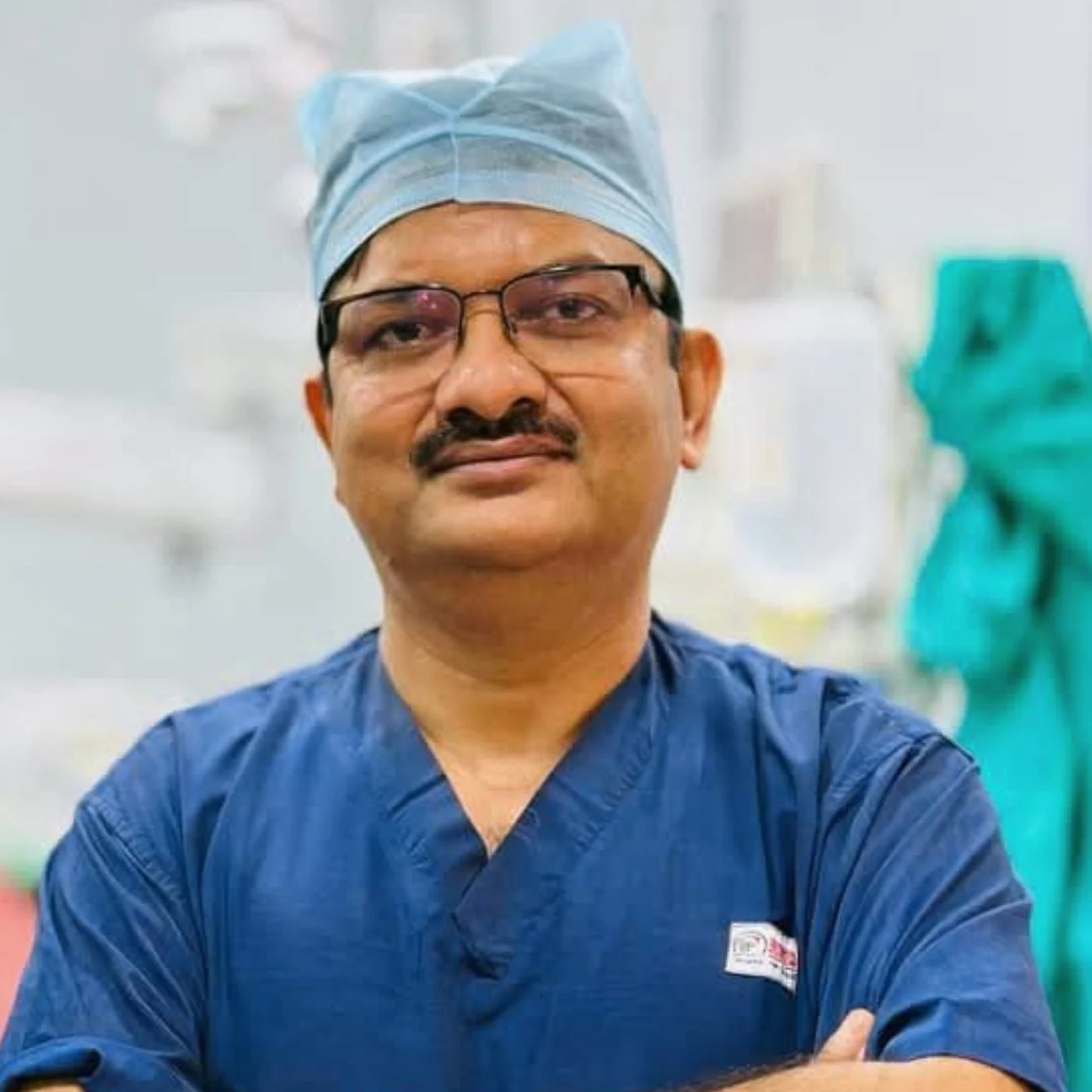 Dr. Tushar Kanti Ghosh wearing blue surgical scrubs